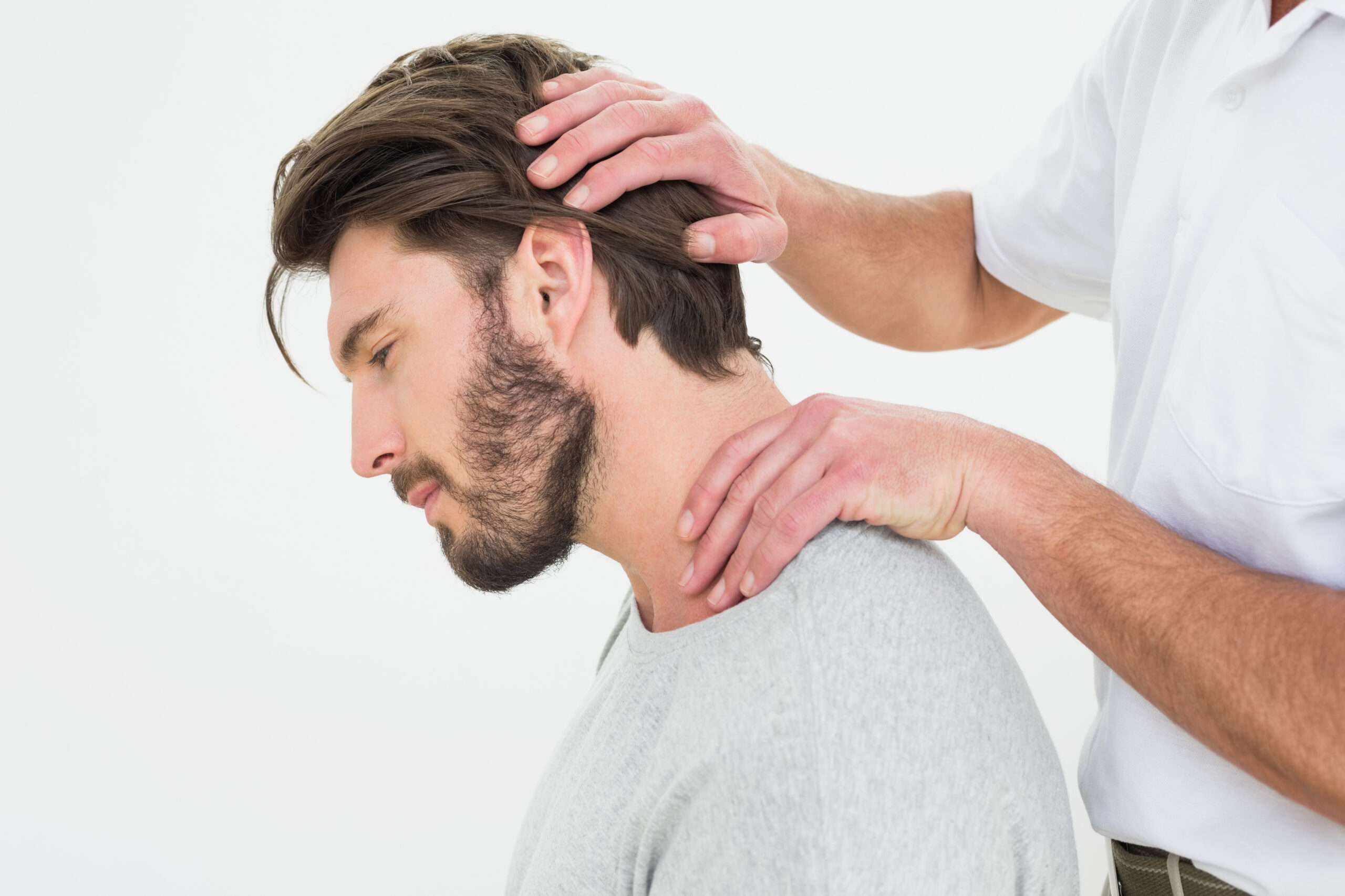 Side view of a man getting the neck adjustment done Chiropractor
